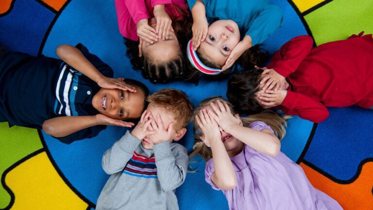 children with their hands on their eyes