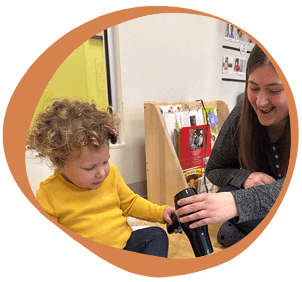 a student with a teacher at one of our daycare facilities