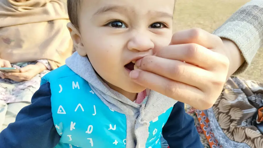 A child biting a hand