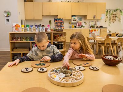 two children working on a project at one of our daycare facilities